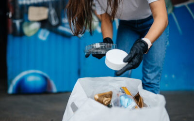 Young woman sorting garbage. Concept of recycling.